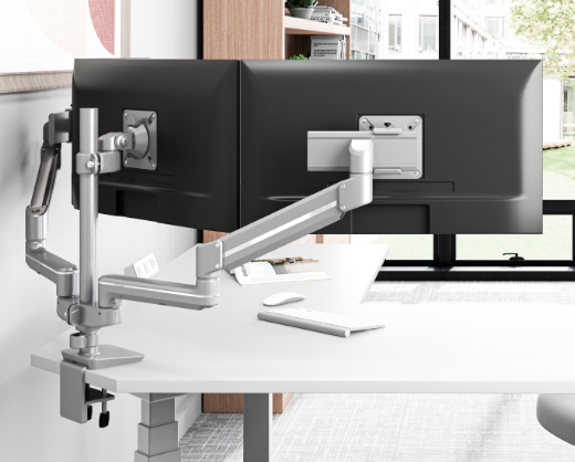 Image of a dual-arm monitor arm on a desk